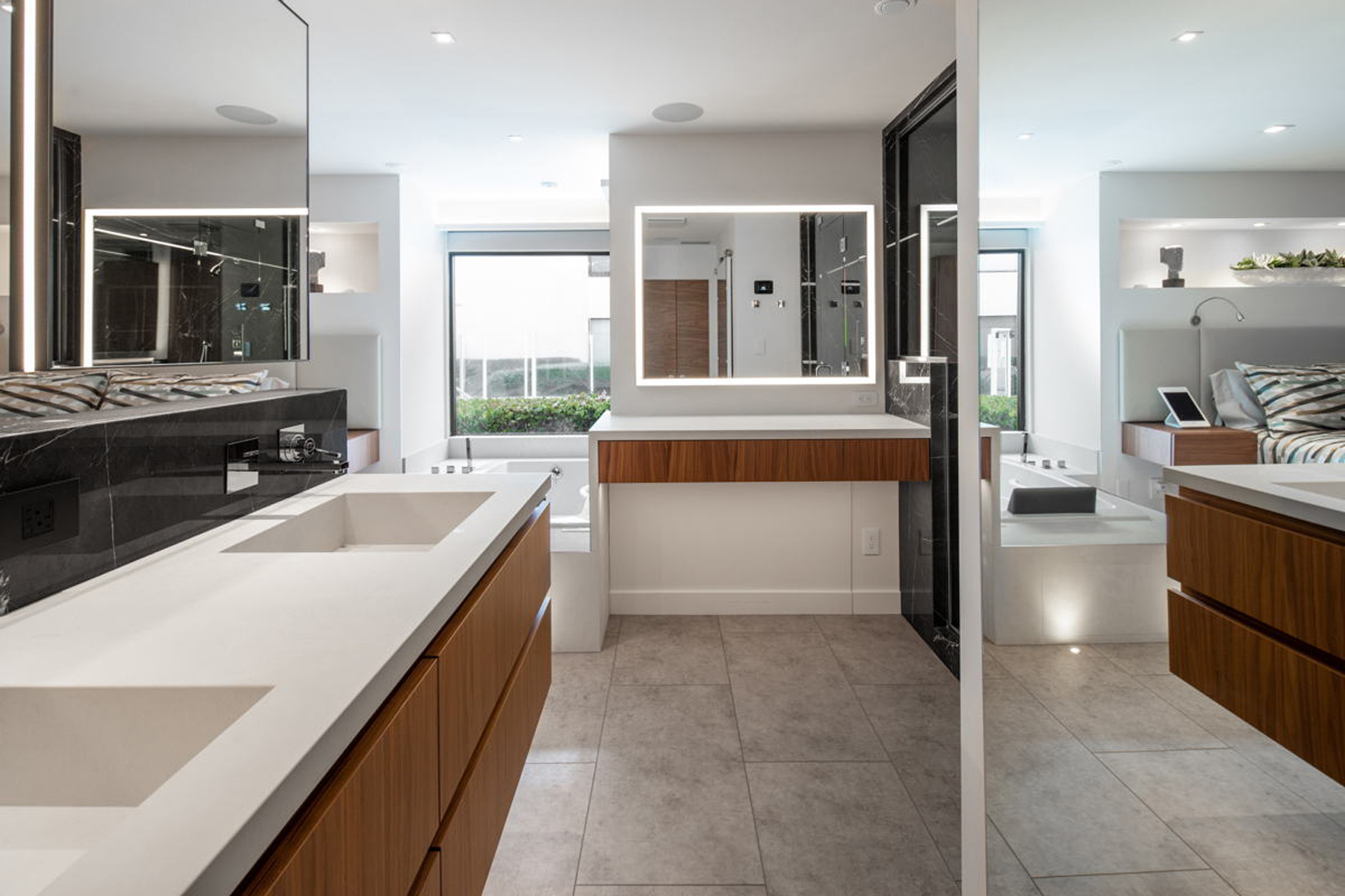 Master bath with dual floating vanities, soaking tub, and bedroom view