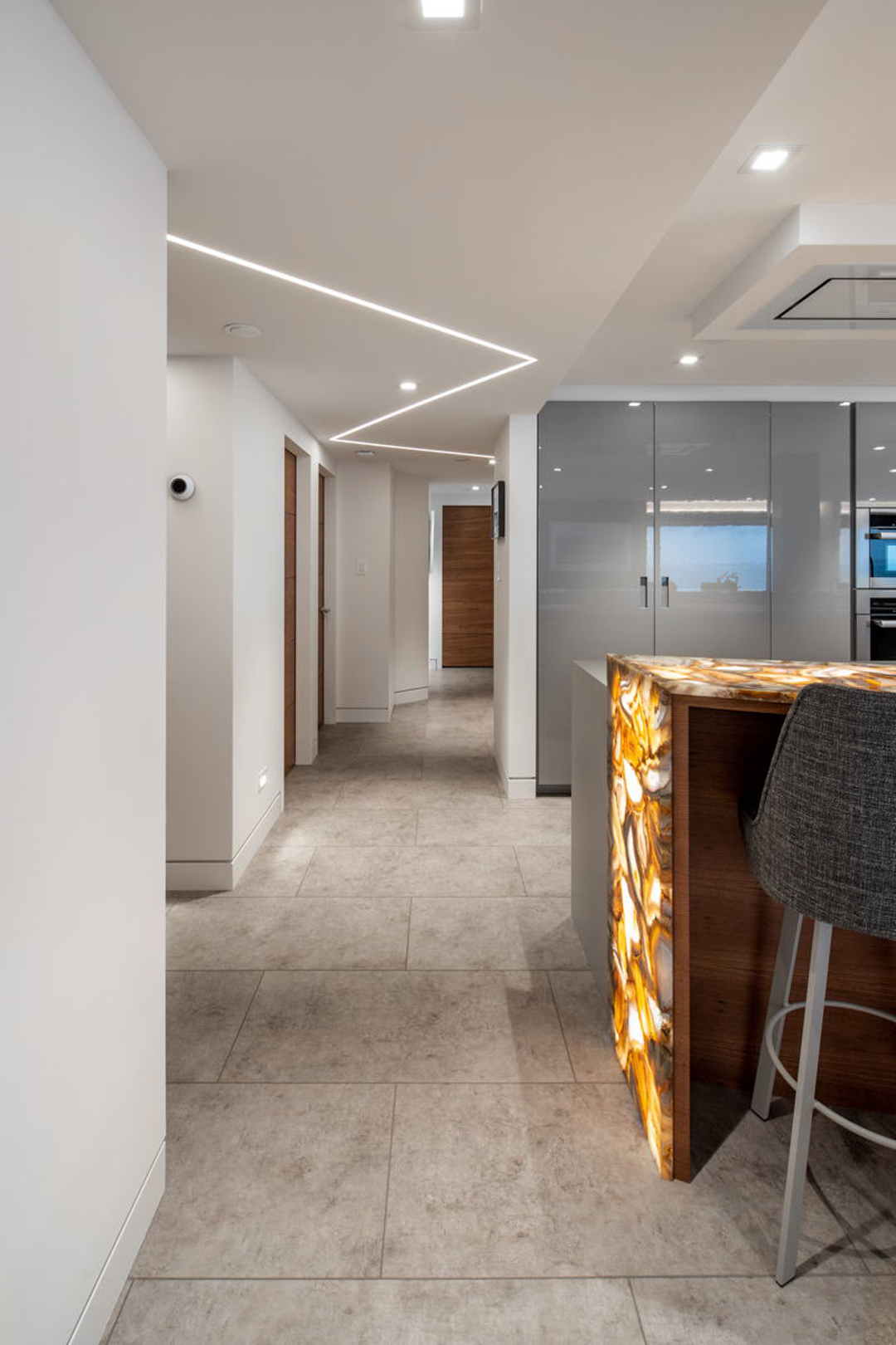 Hallway with LED cove lighting and walnut doors