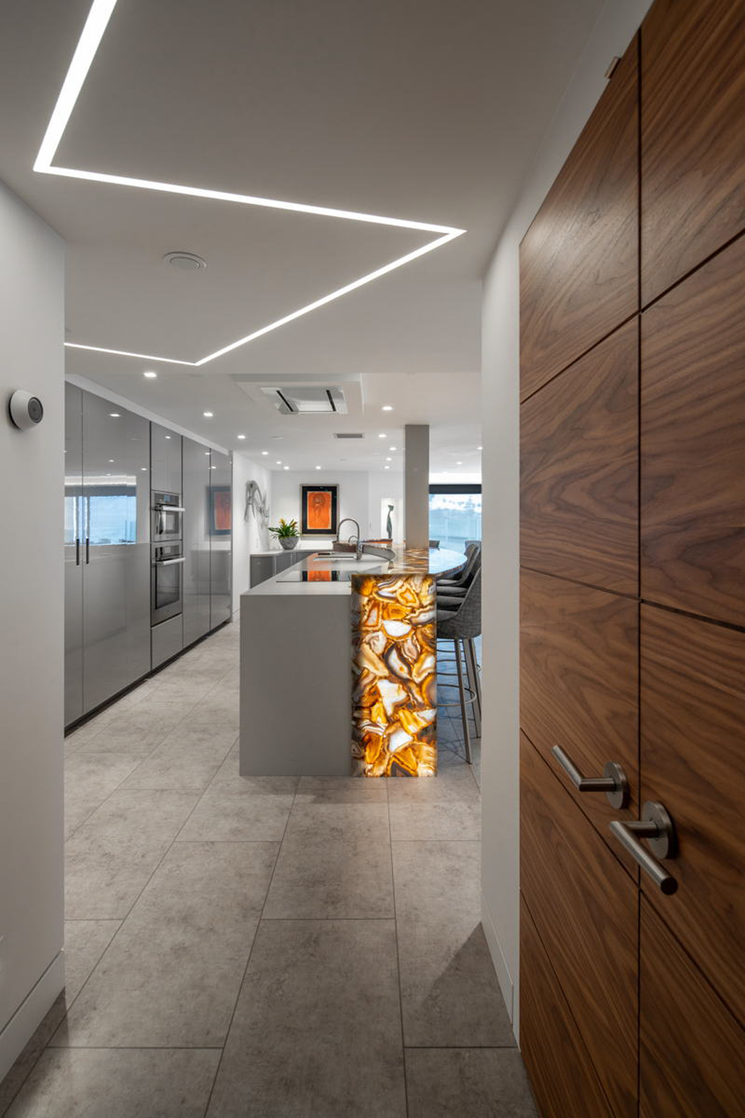 Kitchen hallway view with backlit onyx bar end
