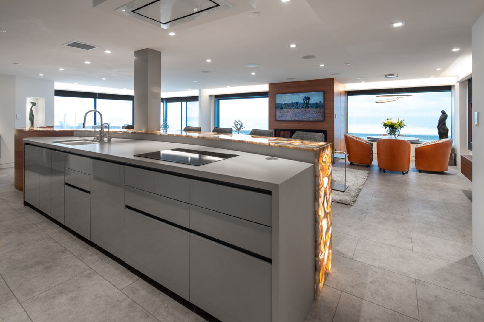 Full kitchen island with ocean view windows beyond