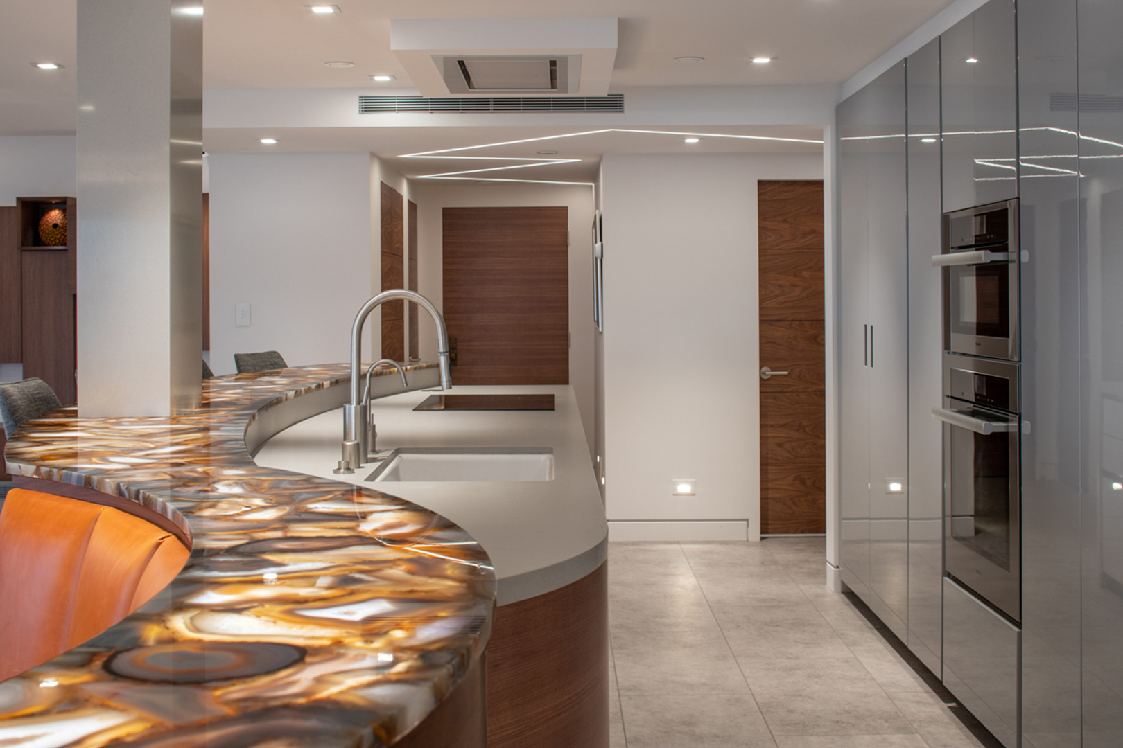 Onyx counter detail with appliance wall and mirrored panels