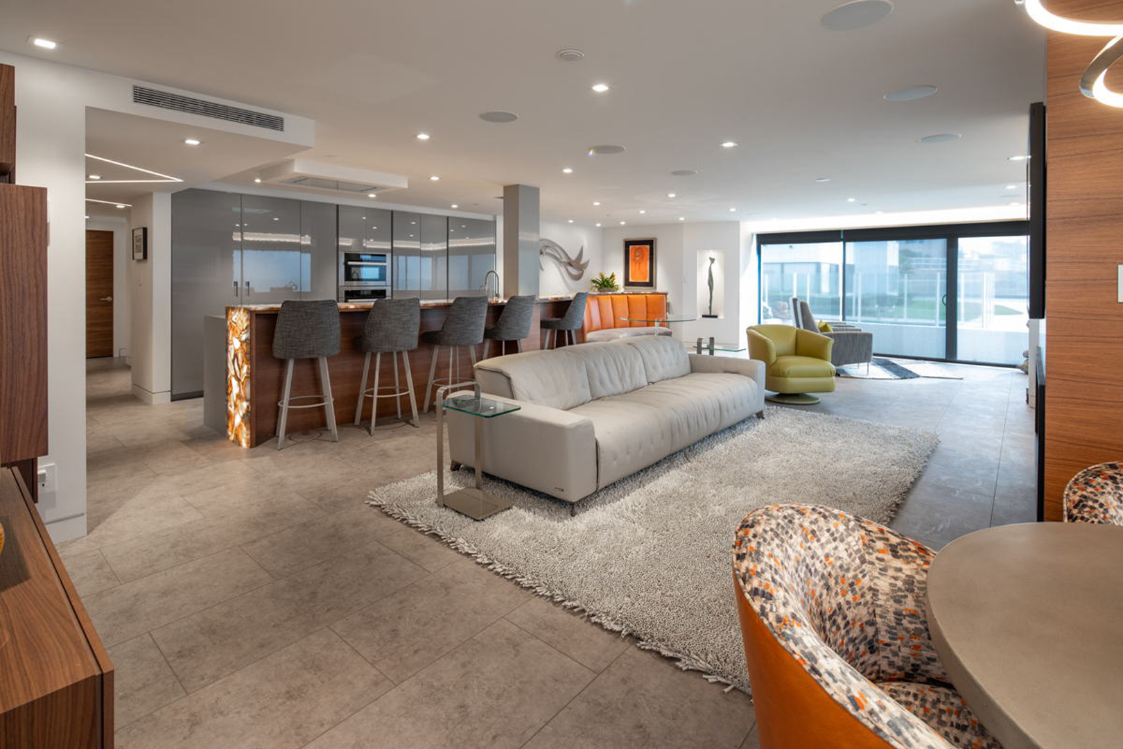 Living room wide view with sliding glass doors to oceanfront terrace